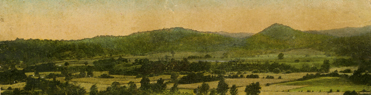 Small, green hills rise above the rural valley of Albany, Indiana