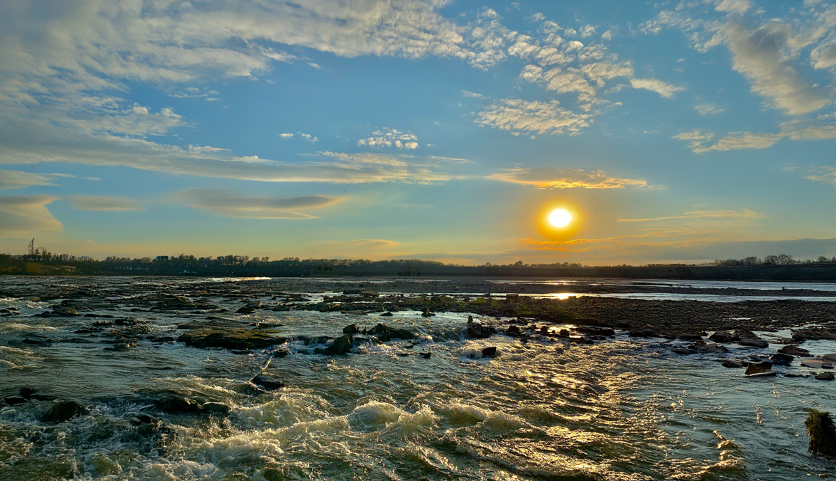 Rapids at the Falls of the Ohio with the sunset in the background