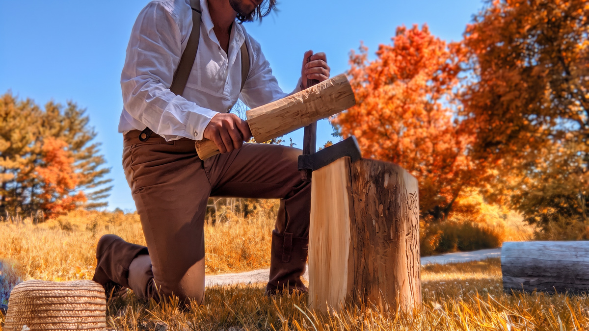 A man is riving a log with a froe