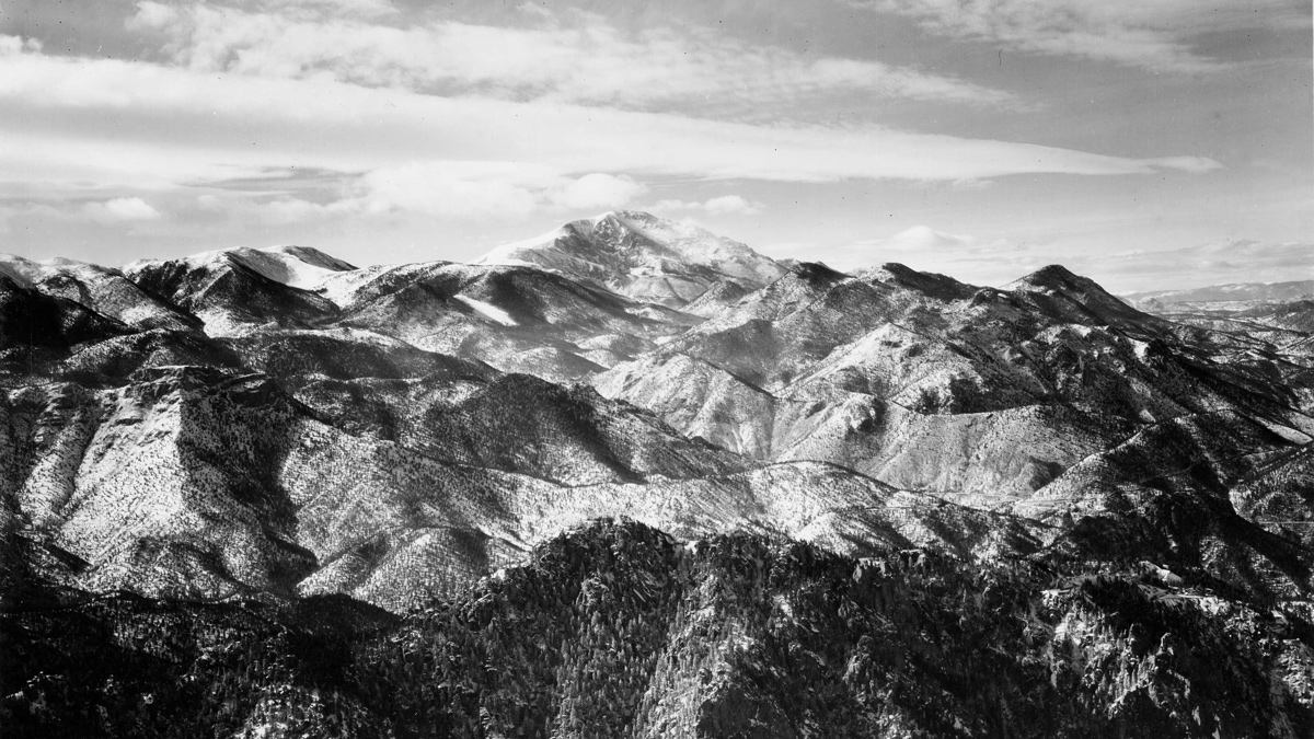Pikes Peak stands out above very mountainous country