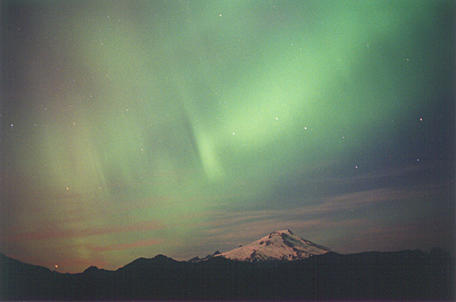 Blue-green streaks over a snow peak