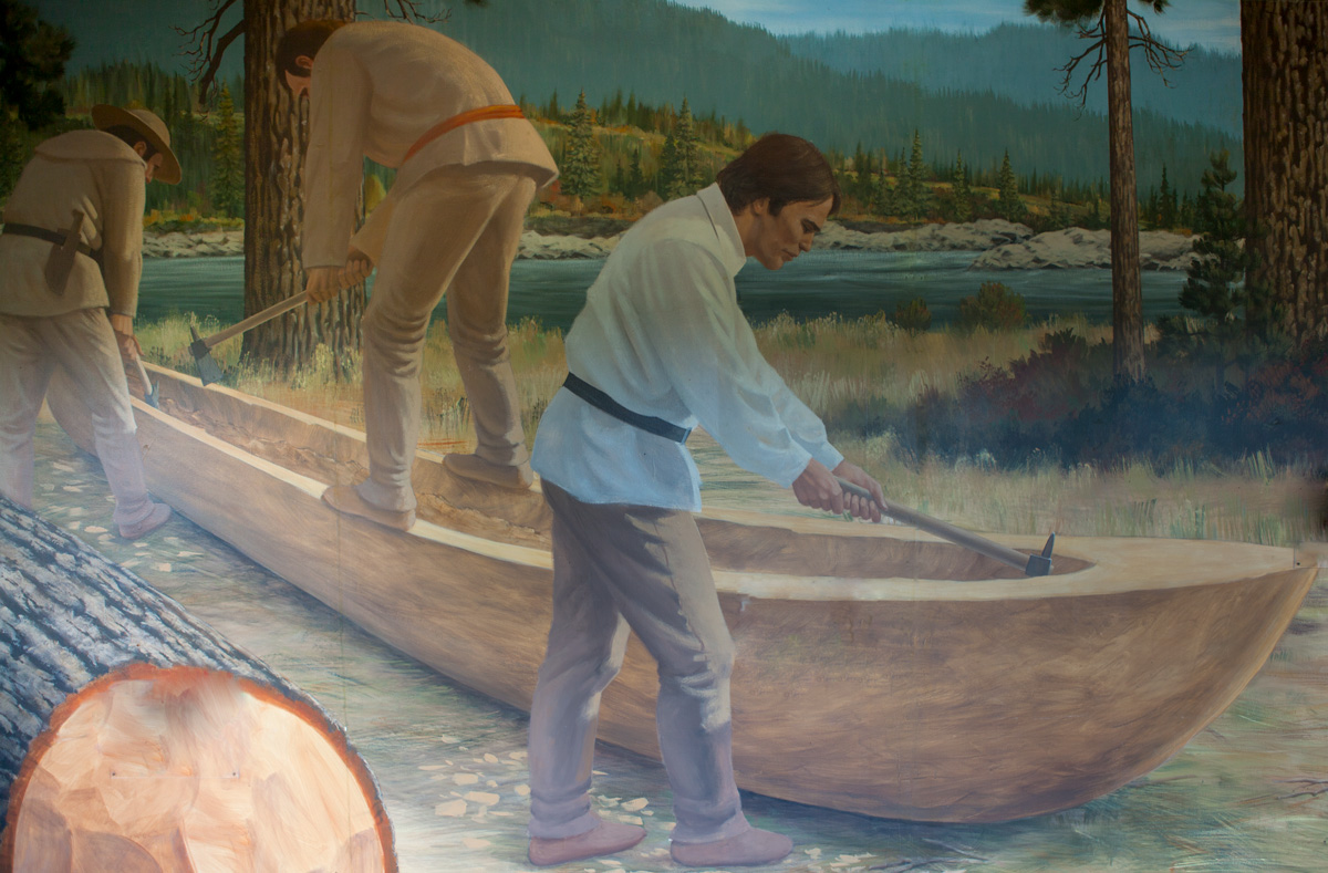 Interpretive painting of three men carving a canoe out of a big log