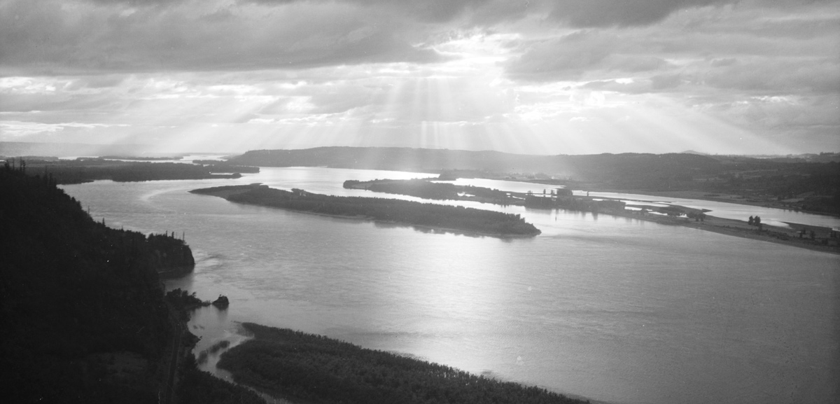Historic photo of a beach and a rock on the river shore