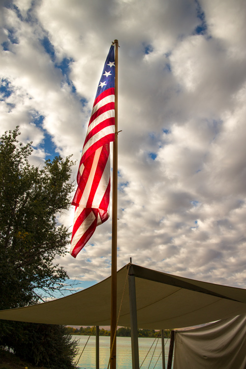 Canvas tent and awning and a flag