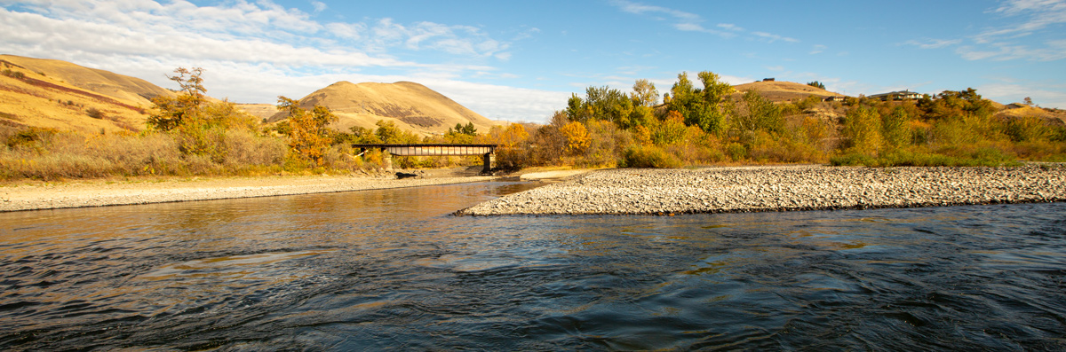 A small river cuts a channel through a rock bar
