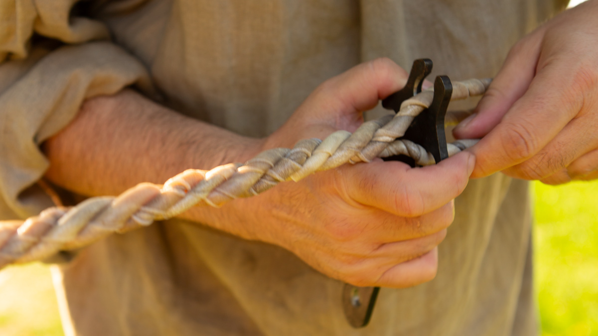 A 19-century worker 'braiding' a rope with the help of an iron tool
