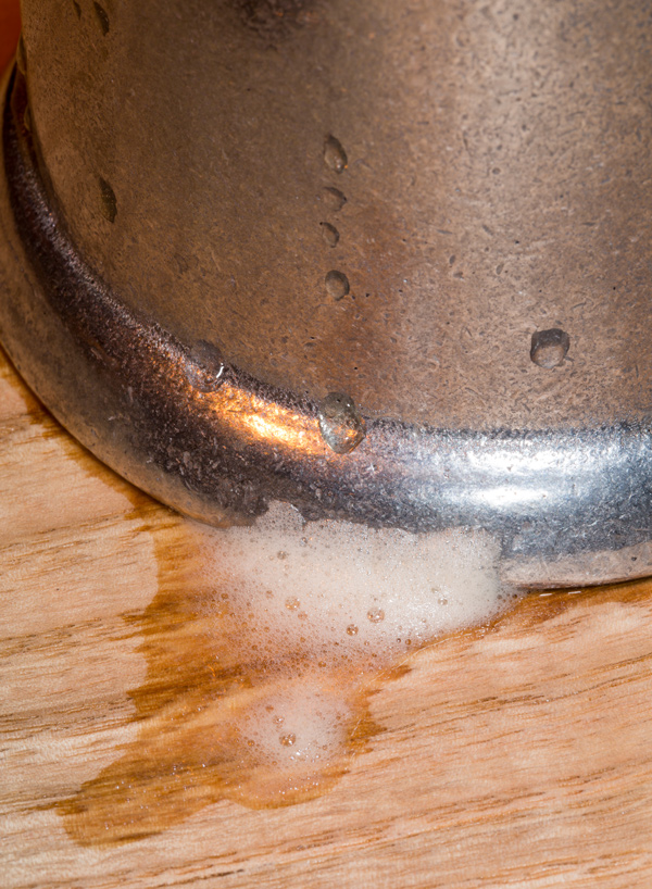 Beer foam beneath a pewter tankard