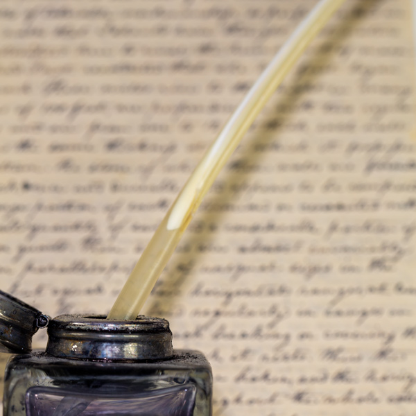 Feather quill, ink stand, and letter